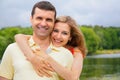 Young woman embraces man from back Royalty Free Stock Photo