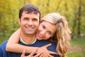 Young woman embraces man from back in autumn Royalty Free Stock Photo