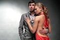 Young woman embraces man. Woman in a red dress. Royalty Free Stock Photo