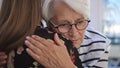 Young woman embracing an elderly lady. Grief and bead news, empathy concept Royalty Free Stock Photo
