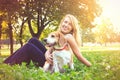 Young woman embracing her beagle puppy dog in the park Royalty Free Stock Photo