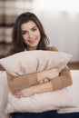 Young woman embracing pillow