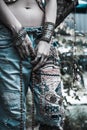 Young woman in embroidered blue jeans boho style hands with bracelets and rings summer fashion Royalty Free Stock Photo