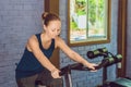 Young woman is engaged on a bicycle in the gym Royalty Free Stock Photo