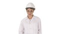 Young woman engineer in hard hat walking on white background. Royalty Free Stock Photo