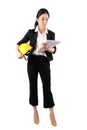 Woman engineer holding a yellow helmet and reading construction documents on white background