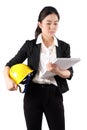 Woman engineer holding a yellow helmet and reading construction documents on white background