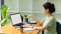 Young woman engineer sitting at the desk, working on laptop Royalty Free Stock Photo