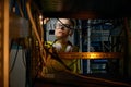 Young woman IT engineer working in datacenter room connecting cables