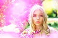 Young woman enjoy flowers in garden, defocused, close up. Lady in park on spring day. Spring bloom concept. Girl on Royalty Free Stock Photo