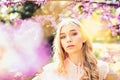 Young woman enjoy flowers in garden, defocused, close up. Spring bloom concept. Lady in park on spring day. Girl on Royalty Free Stock Photo