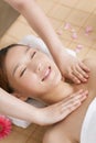 A young women lying in bed enjoying massage Royalty Free Stock Photo