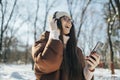 Young woman enjoy winter day and listening music