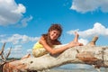 Young woman enjoy in yoga practice outdoor on river beach at freash air sunny summer day