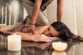 Young woman enjoying the acupressure techniques of Thai massage