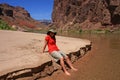 Young woman enjoying the beach above Hance Rapids in the Grand Canyon.