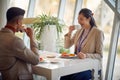 A young woman is enjoying coffee with male colleague at the lunch break during a business conference. Business, people, company Royalty Free Stock Photo