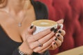 Young woman enjoying coffee time. Attractive caucasian girl in a cafe drinking a cup of coffee Royalty Free Stock Photo