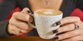 Young woman enjoying coffee time. Attractive caucasian girl in a cafe drinking a cup of coffee Royalty Free Stock Photo