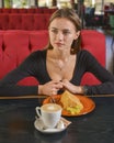 Young woman enjoying coffee time. Attractive caucasian girl in a cafe drinking a cup of coffee Royalty Free Stock Photo