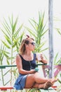 Young woman enjoying cold drink in a beach bar Royalty Free Stock Photo