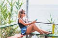 Young woman enjoying cold drink in a beach bar Royalty Free Stock Photo