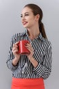 Young woman enjoying cup of coffee in studio Royalty Free Stock Photo