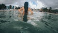 Young woman enjoying the delicious water of the caribbean sea, while looking towards the shore of the beach in early spring on a Royalty Free Stock Photo