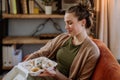 Young woman enjoying delivered food in her living room. Royalty Free Stock Photo