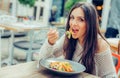 Young woman enjoying food in a restaurant, having her lunch break Royalty Free Stock Photo