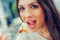 Young woman enjoying food in a restaurant, having her lunch break Royalty Free Stock Photo