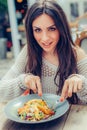 Young woman enjoying food in a restaurant, having her lunch break Royalty Free Stock Photo