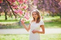 Young woman enjoying her walk in park during cherry blossom season on a nice spring day Royalty Free Stock Photo