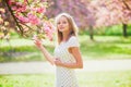 Young woman enjoying her walk in park during cherry blossom season on a nice spring day Royalty Free Stock Photo