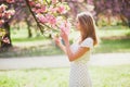 Young woman enjoying her walk in park during cherry blossom season on a nice spring day Royalty Free Stock Photo
