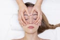 Young woman enjoying massage in spa salon. Face massage. Closeup of young woman getting spa massage treatment at beauty spa salon Royalty Free Stock Photo