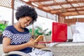 Young woman enjoying a meal at an outdoor cafe, smiling as she looks at her mobile phone Royalty Free Stock Photo