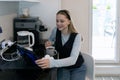 Young woman enjoying morning coffee while using tablet in a modern kitchen setting Royalty Free Stock Photo
