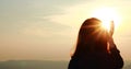 Young woman enjoying and picking beautiful sunrise. Royalty Free Stock Photo