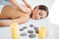 Young woman enjoying relaxing back massage at spa salon Royalty Free Stock Photo