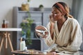 Young Woman Enjoying Skincare at Home Side View Royalty Free Stock Photo