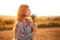 Young woman enjoying smell of flowers in evening Royalty Free Stock Photo