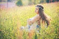 Young woman enjoying spring weather in flower field