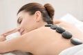 Young woman enjoying stone massage in spa salon Royalty Free Stock Photo