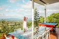 Young woman enjoying summer vacation on a mountain terrace