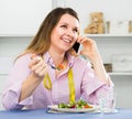 Young woman is enjoying tasty green salad Royalty Free Stock Photo