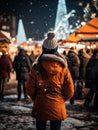 Young woman Enjoying of a traditional Christmas Market and a charming winter holidays