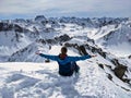young woman enjoying the view from a high mountain peak Alplihorn above Monstein Sertig Davos. mountaineering in winteR