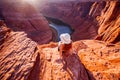 Young woman enjoying view of Horseshoe bend, Arizona. Horseshoe Bend, canyon and Colorado river at sunset. Famous hiking Royalty Free Stock Photo