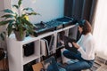 Young woman enjoying vinyl records in cozy room Royalty Free Stock Photo